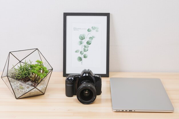 Laptop with picture and camera on wooden table