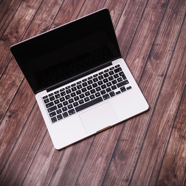 Laptop on wooden background