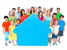 Free photo large group of people holding home symbol