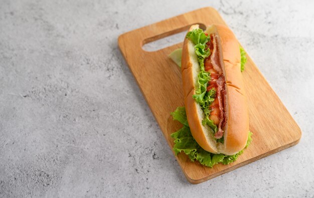 Large hot dog on wood cutting board