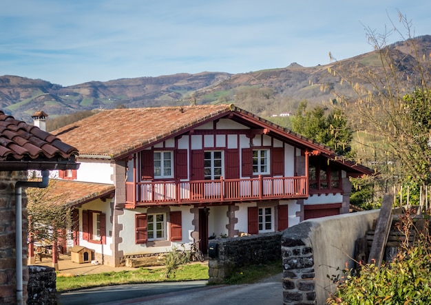 Large house surrounded by mountains and trees