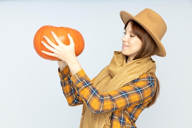 A large juicy pumpkin in a womans hands closeup