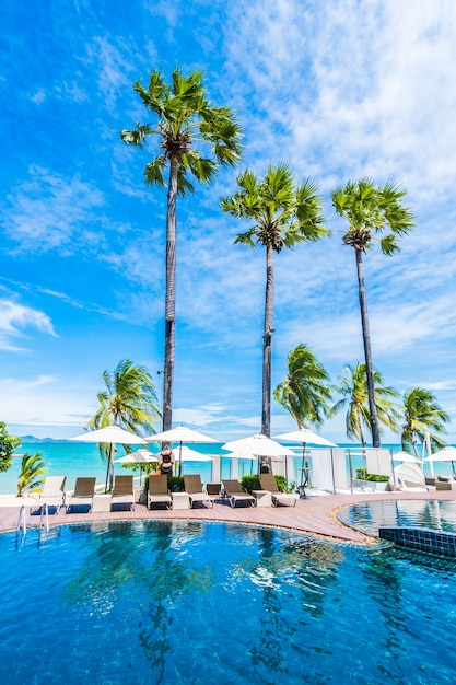 Free Photo large palm trees and a pool