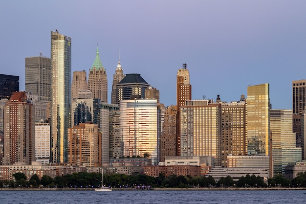 Large stone buildings in downtown New York at sunse