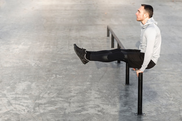 Free photo lateral view athletic man working out outside