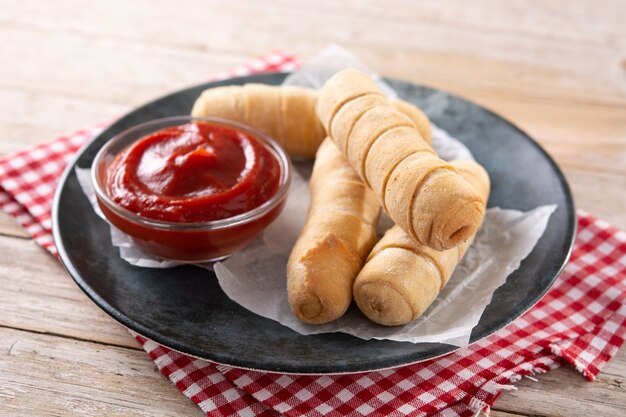 Latin American tequenos stuffed with cheese on wooden table