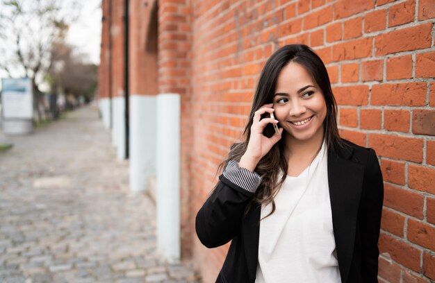 Latin woman talking on the phone.