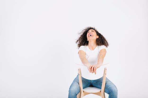 Free photo laughing brunette on chair