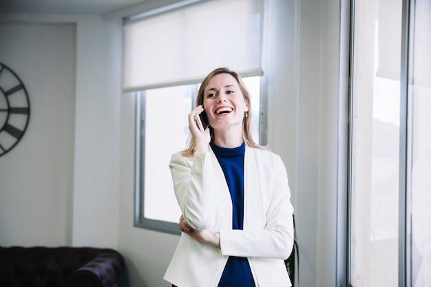 Laughing businesswoman on phone