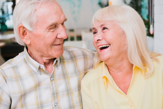 Laughing delighted senior couple