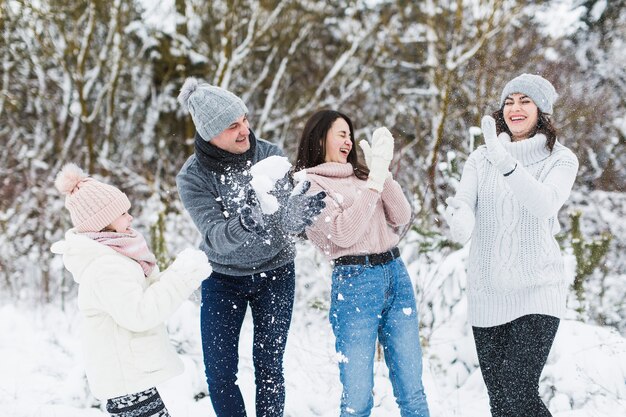 Laughing family in winter forest