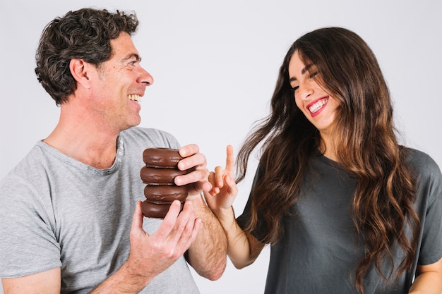 Free photo laughing father and daughter with donuts