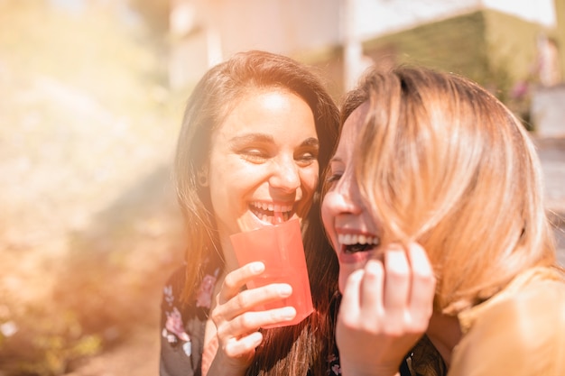 Laughing friends with beverage