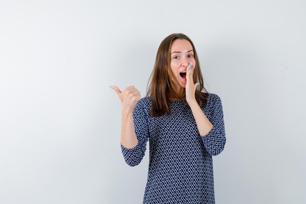 Laughing girl showing back with her left finger on white background