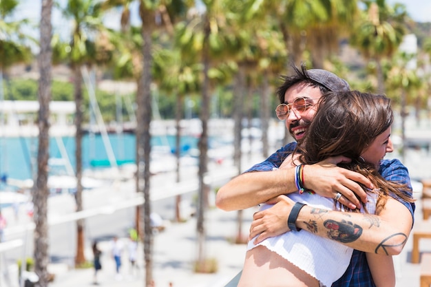 Laughing man and woman embracing