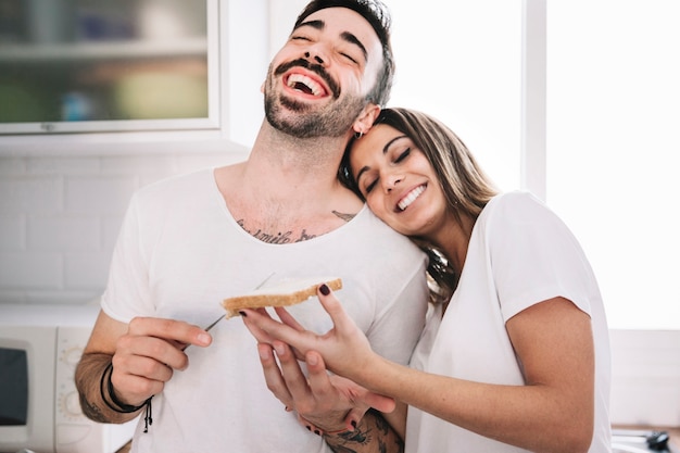 Laughing people making breakfast together