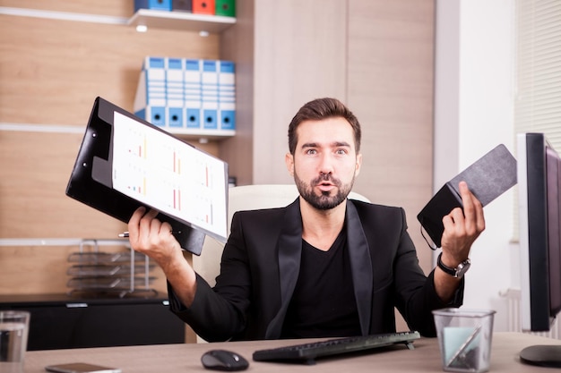 Laughing professional businessman working in his office. Businessperson in professional environment