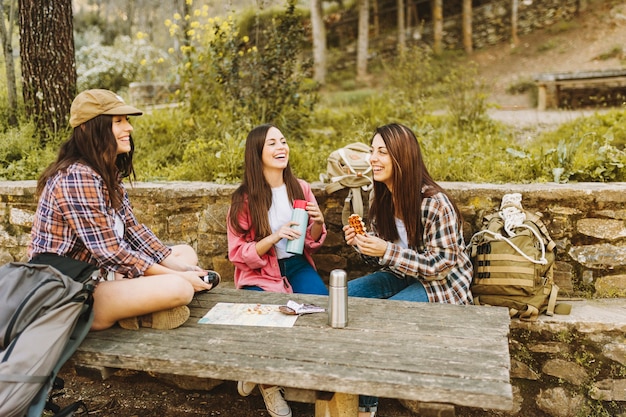 Laughing woman eating during journey