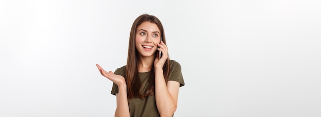 Free photo laughing woman talking and texting on the phone isolated on a white background