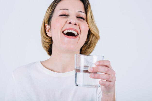 Laughing woman with water glass