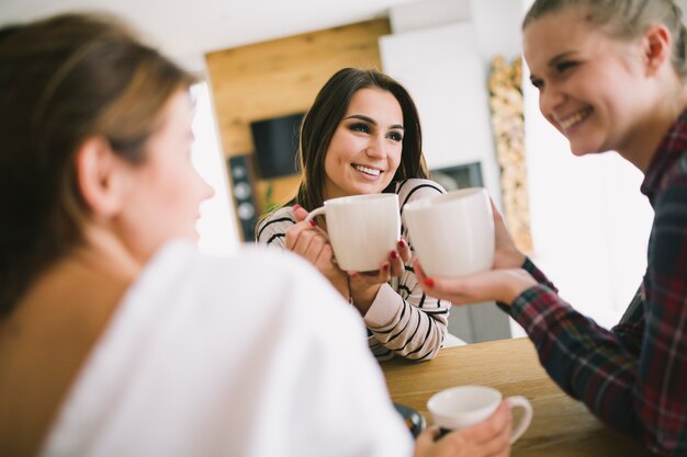 Free photo laughing women enjoying tea and talking