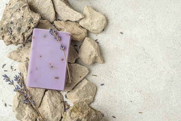 Lavender soap on rocks with copy space