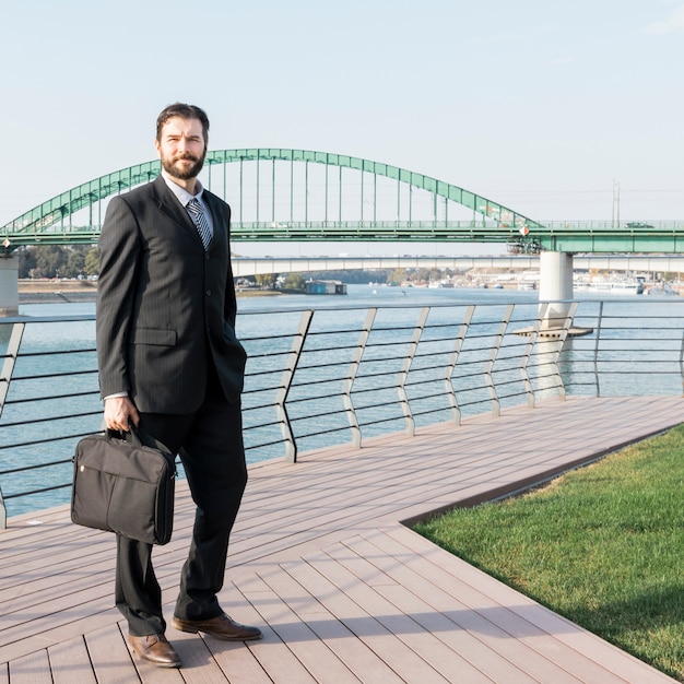 Lawyer with briefcase by the river