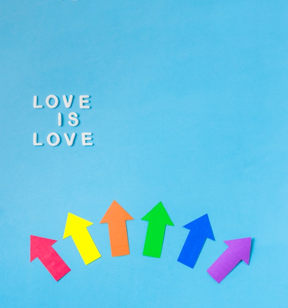 Free Photo layout of paper arrows in lgbt colors and love is love words