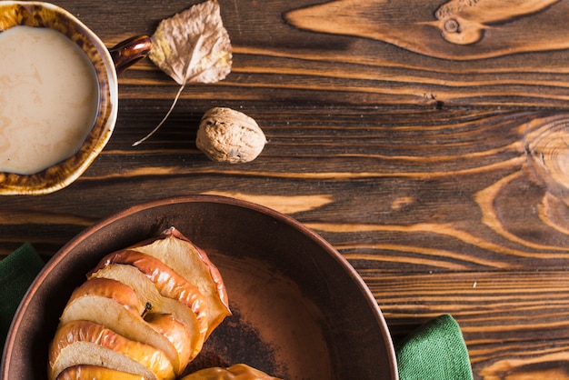 Leaf and walnut near drink and baked apple