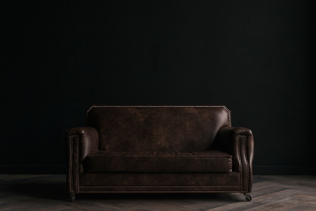 Free photo leather couch in dark room