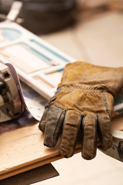 Free photo leather gloves on artisan job table