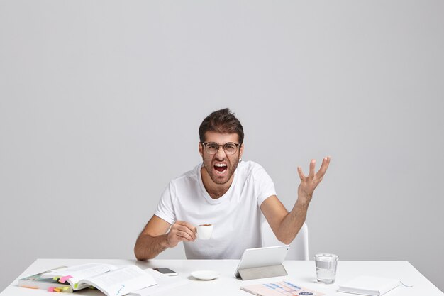 Leave me alone. Headshot of annoyed furious exasperated unshaven businessman making irritated gesture