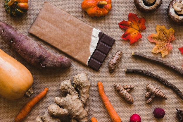 Free photo leaves and vegetables lying near chocolate