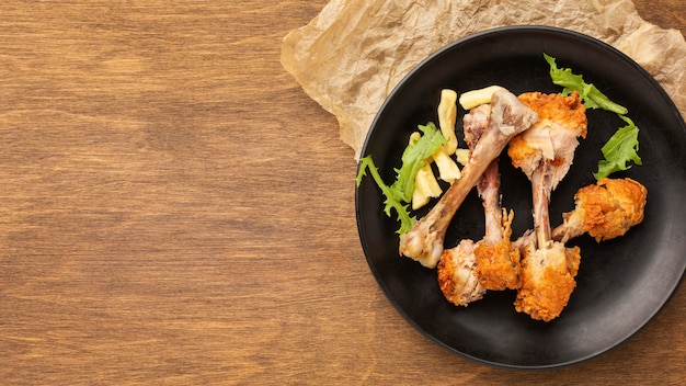 Leftover food waste drumsticks in plate