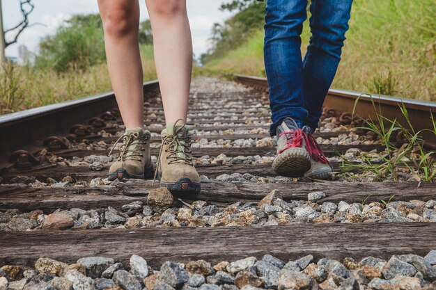 Leg view of couple on train tracks