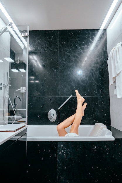 Free photo legs of beautiful young female in bath tub