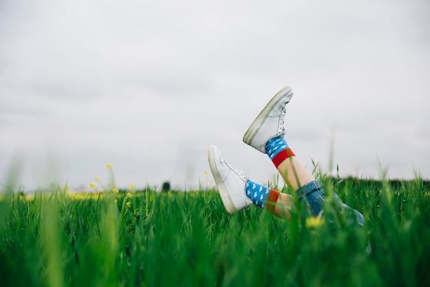 Legs in white shoes and above grass