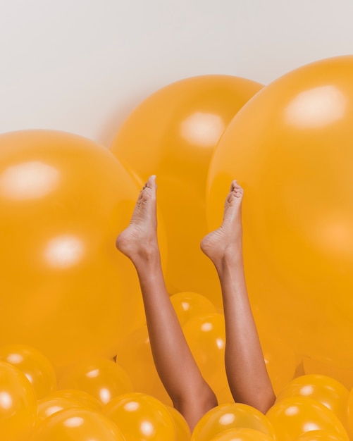 Free Photo legs of woman between many yellow balloons