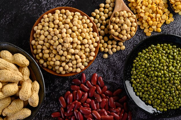 Legumes, and beans assortment on the black cement floor.