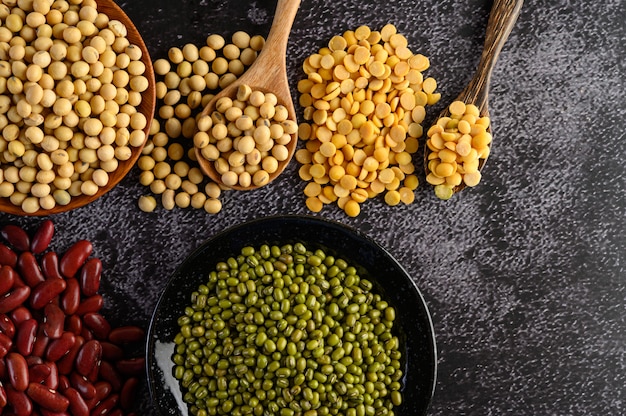 Free photo legumes, and beans assortment on the black cement floor.