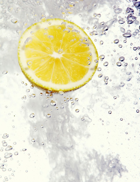 Lemon dropped into water