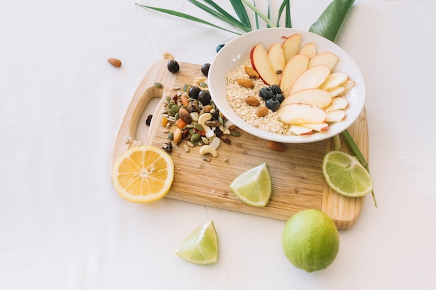 Free Photo lemon; dryfruits and oatmeals on white background