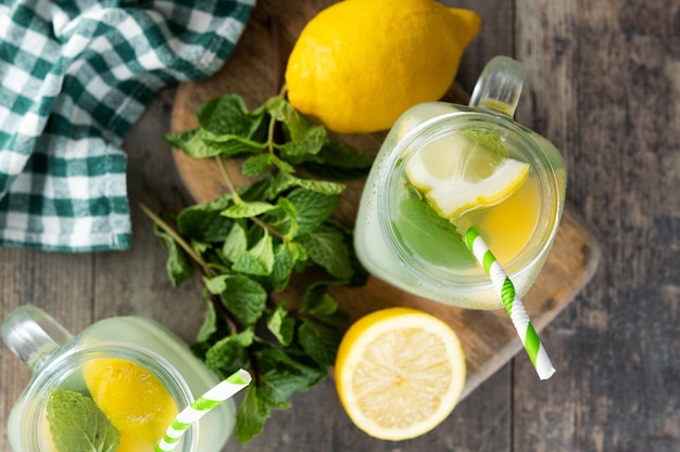 Free photo lemonade drink in a jar glass and ingredients on wooden tablexa