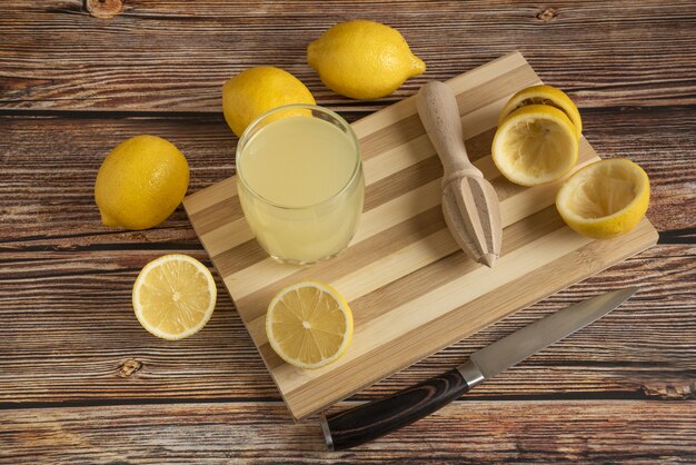 Lemonade in a glass cup on the wooden board