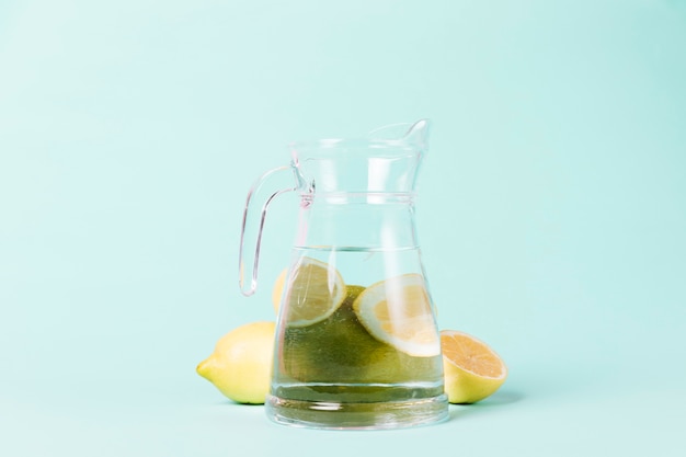 Free photo lemons and jug on blue background