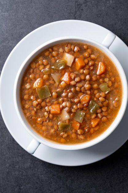 Free photo lentil soup with vegetables in bowl on black background