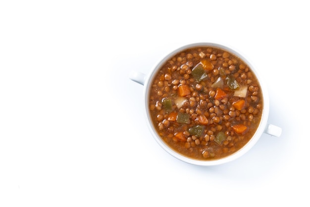 Lentil soup with vegetables in bowl isolated on white background