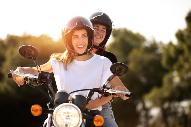 Lesbian couple on a motorcycle with helmets on