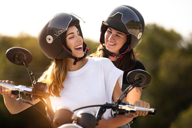 Lesbian couple on a motorcycle with helmets on