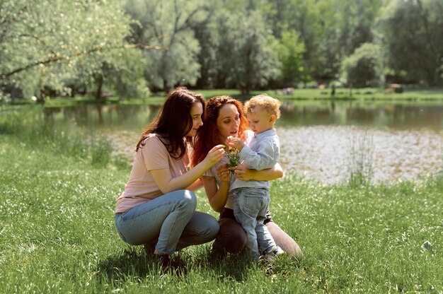 Lesbian couple spending time with their kid in the park